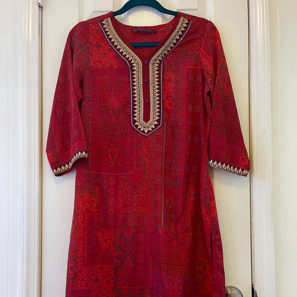 Red patterned long tunic with gold embroidery.